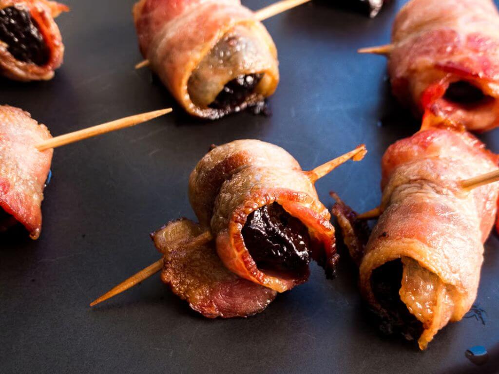 Bacon-wrapped dates as a savoury appetiser for a festive grazing board