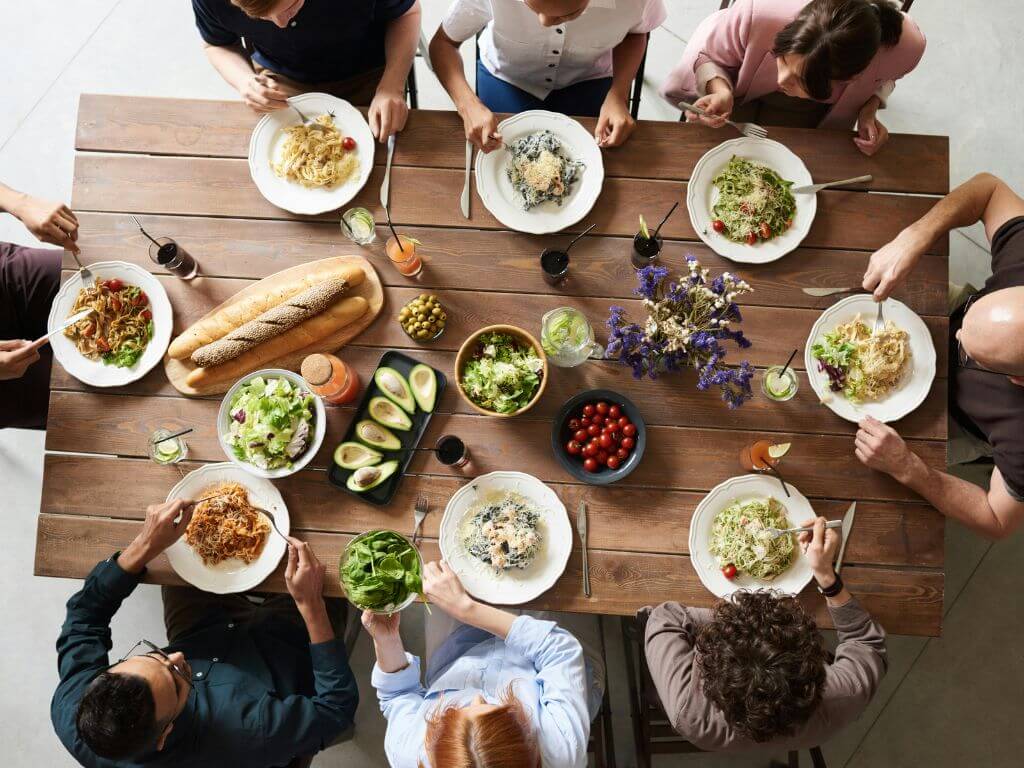 A group of people enjoying a meal together around a table.