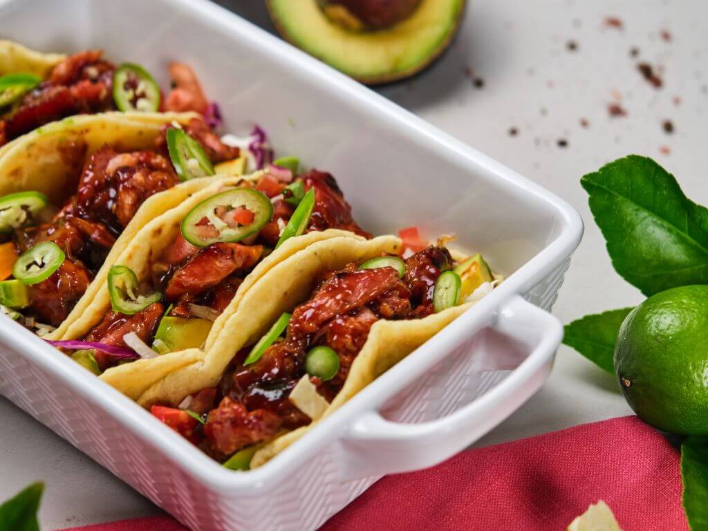 Close-up of Frey’s sticky rib tacos with jalapeños and fresh toppings.